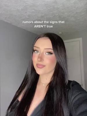 A woman with long dark hair and makeup is centered in the frame. The text "rumors about the signs that AREN'T true" appears above her head.