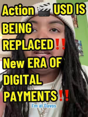 The cover image features a close-up shot of a person with long black dreadlocks and a white beanie. Text overlays in a yellow font with black outlines announce "Action USD IS BEING REPLACED!! New ERA OF DIGITAL PAYMENTS!!" Below the text is a banner stating "I'm at Davos". The background hints at a green wall with framed pictures. The person is looking directly at the camera and appears to be speaking. A silver cross necklace is visible.