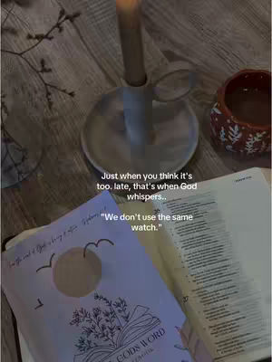 A dimly lit image featuring a wooden surface with open books, a lit candle, and a small ceramic pot. Text overlays guide the viewer to a message about trust and faith.