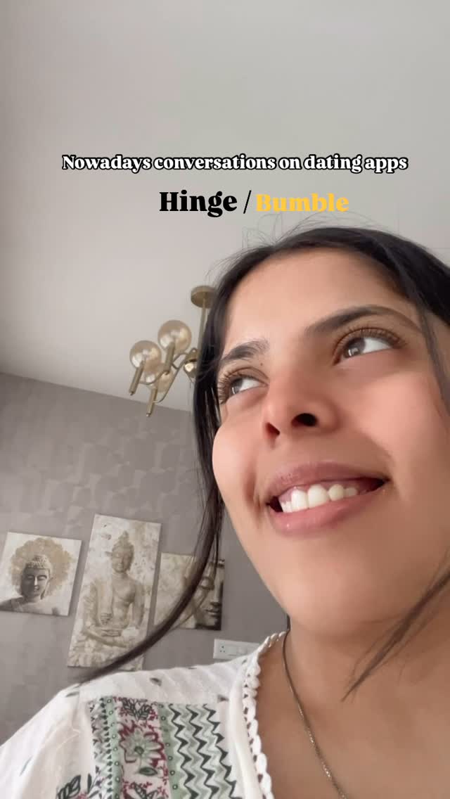 A selfie-style shot featuring a young woman looking upwards and slightly to her right, with a soft smile. The background is composed of a textured, grey-toned wall and a glimpse of a ceiling with overhead light fixtures. Text overlays appear, with app names, in a stylish format.
