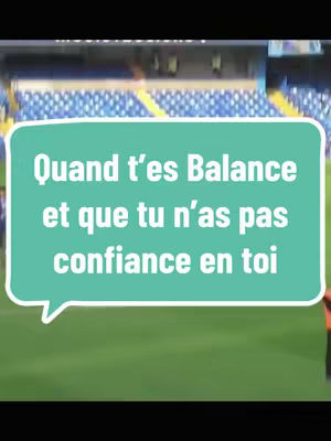 The image shows a green field with a stadium in the background. In the center, a turquoise speech bubble contains white text.