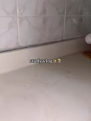 A close-up shot of a white countertop surface, with a tiled wall in the background. The surface is in the foreground and angled slightly up. The text overlay is in the lower left with the words 'study vlog' and a few emojis.