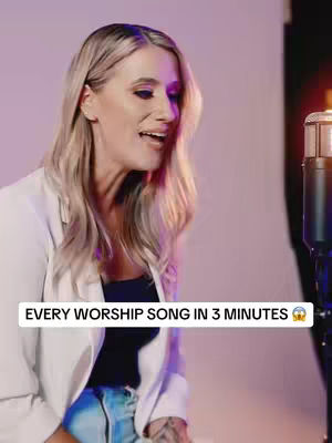 A woman with blonde hair, wearing a white blazer and dark top, is positioned to the left of the frame, her head turned towards the right with an open mouth as if singing or speaking with excitement. A microphone is on the right side of the frame. Text overlay at the bottom says, "EVERY WORSHIP SONG IN 3 MINUTES 😳". The background has a soft pink and purple gradient.