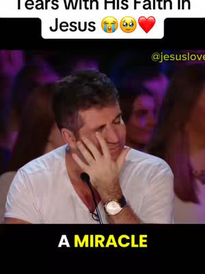 The cover image features a close-up of Simon Cowell from Britain's Got Talent, wiping away tears. He's wearing a white shirt and a watch. The background suggests a stage setting with blurry figures. Added text at the top says 'Tears With His Faith In Jesus' with emojis. At the bottom is the text 'A MIRACLE'.