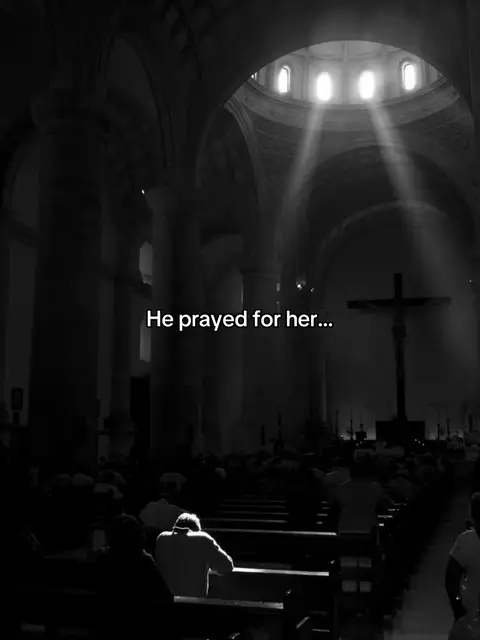 A black and white image of a cathedral interior. Sunlight streams through the high windows above, illuminating a cross and the pews filled with people. The text 'He prayed for her...' is overlaid at the bottom.