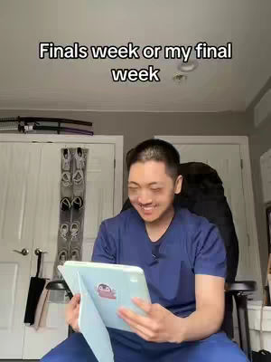 A young Asian man is seated indoors, holding a tablet. He's smiling while looking at the tablet. Above, the text overlay 'Finals week or my final week' is present.