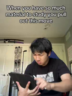 A young Asian man is seated indoors, holding a tablet and a stylus, with a focused expression. The background includes a white door, a shoe rack, and a microphone stand.