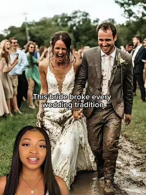 The image shows a candid scene from a wedding, the bride and groom are in the center.The bride is wearing a mud-covered wedding dress, and the groom is also covered in mud, wearing a suit. They are holding hands and smiling widely at the camera. The background has wedding guests and nature. The creator's face is at the bottom, showing happy expression.