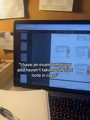 A laptop displaying a study guide is the central focus, with an open notebook and pen in the foreground. Post-it notes and other papers are pinned to the wooden surface behind the laptop. The scene suggests a study environment.