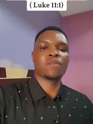 A man in a black button-down shirt is looking at the camera in a medium shot. A text overlay in a white rectangle at the top of the image reads \"(Luke 11:1)\". The background is a gradient of purple and pink.