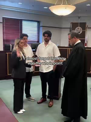 A group of people are in a courtroom. A woman in a black suit is raising her right hand, with two men behind her and a man in a black robe standing opposite them. Text overlayed says, "almost forgot that this was the whole point".