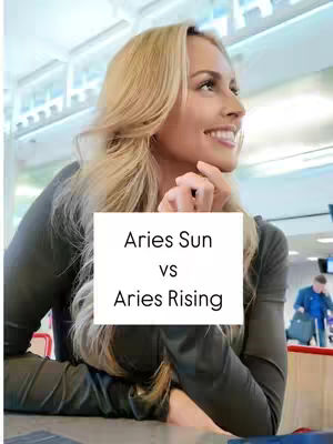 A woman with long blonde hair smiles slightly while looking to her right. Overlayed on the image is a white rectangle with "Aries Sun vs Aries Rising" in black letters.