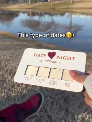 The cover photo shows a person holding a white card in front of a background pond in a park. The card has four sections titled 'What to Eat', 'What to Do', 'After That?', and 'Sexy Time'. The text overlay says 'This type of dating >' over the image.