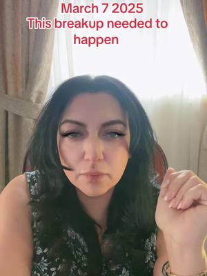 A woman with long black hair is centered in the frame, her expression contemplative. Text overlays at the top read 'March 7 2025' and 'This breakup needed to happen'. The background is softly lit, and she's wearing a patterned top.