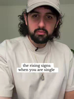 A man with a beard and a cap is the central focus, set against a neutral backdrop. Text overlay positioned at the bottom contains the phrases 'the rising signs: when you are single' against a white background. The man's expression is serious; there is a gold chain.