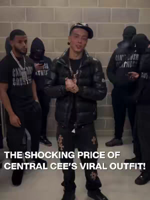 The cover image features a group of people in an indoor setting. The central focus is on a man wearing a black jacket, studded pants. There are other people in the background, some wearing hoodies and some are wearing black balaclavas. The overall composition looks like a backstage or behind the scenes shot.
