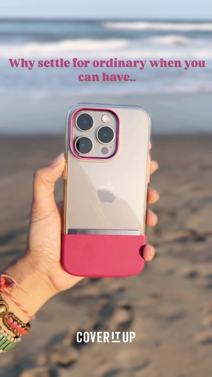 A hand holding an iPhone with a pink and clear phone case, set against a sunny beach with the ocean in the background. The phone case is the focal point, positioned central, with the pink section at the bottom and clear above. The text overlay on the image enhances the phone case's visual appeal.