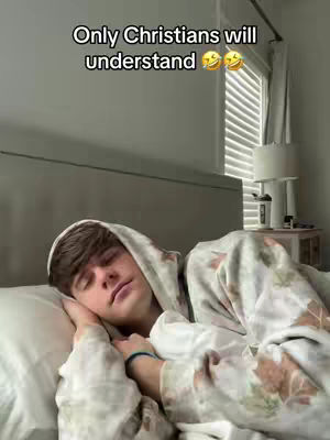 A young man is asleep in bed with a white pillow and a patterned blanket. The text overlay reads "Only Christians will understand". The background includes a window and a lamp.