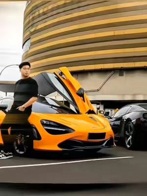 The cover image features a man posed next to an orange sports car with its doors open in front of a building with a unique design.