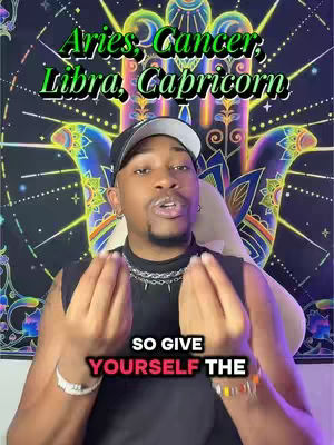 A man with a dark cap and black shirt is in the foreground, pointing at his hands. Behind him is a tapestry with colors and shapes. Text overlays are used to give the zodiac signs.
