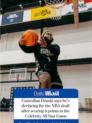 A man in a basketball uniform is shown mid-air, reaching for a basketball as if to score. The image is set in a basketball court, with the hoop and backboard clearly visible in the background. Text from Daily Mail is overlayed at the bottom.