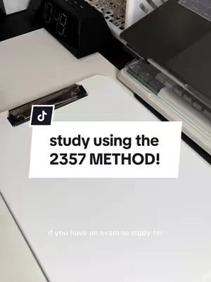 A desk setup with a white top, featuring a black digital clock, a laptop, and a clipboard with a pen. Overlaid on the scene is a white rectangle with the text 'study using the 2357 METHOD!' in bold, black font.