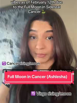 A woman with dark hair is centered in a selfie-style shot. The background is blurred, with indistinct patterns and colors. She looks directly at the camera with a neutral expression. Overlay text highlights the topic of the video, which is about a Full moon in Cancer.