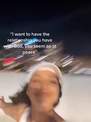 The cover image shows a blurred, close-up shot of the creator, a woman, facing the camera. She is wearing a white top and a white hat, with her face slightly out of focus. The background is a blurry representation of a city at night.