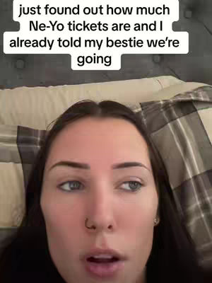A close-up shot of a young woman's face, emphasizing her eyes and mouth. The woman has long dark hair, and is looking slightly off-camera, with text added at the top of the image in a white box, with the words about Ne-Yo tickets.
