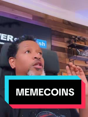 A man with short, dark hair and a goatee is speaking into the camera. The background features a textured wooden wall and a sign that says 'Power of Fish'. The bottom third of the screen is a rectangular overlay with the word 'MEMECOINS'.