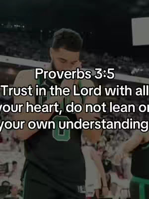 A man in a basketball jersey stands in a dimly lit indoor setting, possibly a stadium. Overlayed text provides a Bible verse.