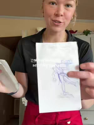 A woman holding up a drawing of a server, pointing towards the drawing while looking at the camera, with text overlayed.