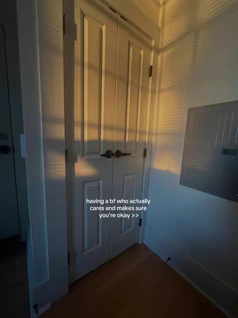 The image shows a doorway with two white doors and a light tan wall. The walls are lit by sunlight casting shadows.  Text is overlayed on the image.