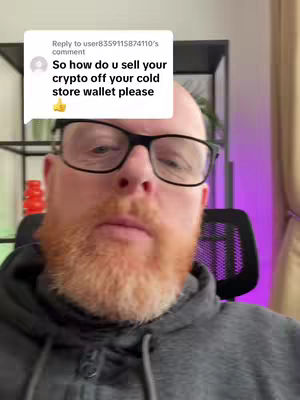 A middle-aged man with a red beard wearing a grey hoodie and glasses is centered in the frame, answering a viewer's comment about selling crypto from a cold storage wallet. A white speech bubble with black text from a viewer is in the top left corner.