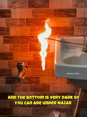 A low-angle shot showcases a bathroom scene dominated by warm brown brick-patterned tiles on the wall. A sink with a chrome faucet is on the right, beside the tile. A flame, seemingly lit from a rod on a hand, is in the center. Text in the bottom describes the scene. The overall lighting is warm and artificial.
