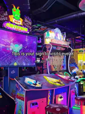 The cover image showcases an arcade with various gaming machines in a dimly lit environment. The colors are vibrant, featuring neon lights around the gaming machines, with the text overlayed on the cover image, inviting viewers to visit Level X.