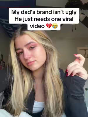 A young woman with long blonde hair and red eye makeup is looking at the camera in a crying or sad pose, a message box says: My dad’s brand isn’t ugly, He just needs one viral video