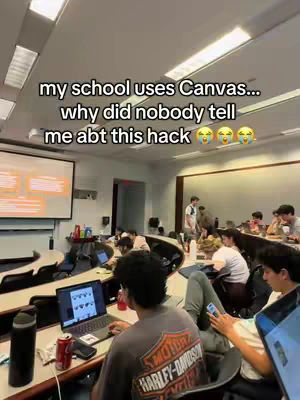 A classroom setting with students working on laptops. A screen displays content at the front, and a visible hook overlayed on the image.