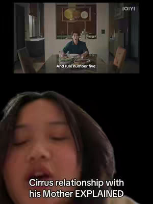 A woman with dark hair and an open mouth appears in the foreground, likely speaking. Below her is overlaid text, and behind her two frames of a video clip, inside of a dining room.