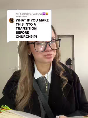 A person with long blonde hair wearing glasses and a black coat, is looking at the camera. A white speech bubble is in the upper-left corner with text overlayed. The background includes a partially visible door.