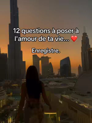 A cityscape at dusk with a woman standing with her back to the camera, looking out over the city, buildings in the background and text overlayed.