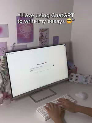 A first-person perspective showcases a desk setup with a computer monitor displaying a blank ChatGPT interface. The creator's hands are visible, typing on a white keyboard. In the background, there's a plain white wall adorned with artwork. The overall composition suggests a focus on productivity and AI-assisted writing.