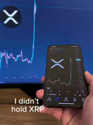 The image shows a person holding a smartphone displaying a graph and the XRP logo. A larger screen behind the phone also shows a graph. The overlay text says, 'I didn't hold XRP'.