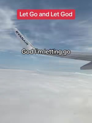 The image shows a view from an airplane window. The wing of the plane is visible, with the Ryanair logo clearly displayed on the wing. Below, white clouds are visible, with a blue sky in the background. Text overlays read Let Go and Let God in a red box, and God I'm letting go.