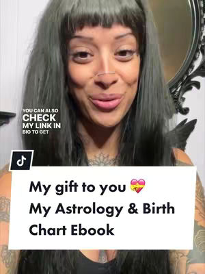 A woman with dark hair, styled with bangs, stands in front of a mirror. She's wearing a dark top and has a nose ring. Text overlays include prompts to check the link in the bio and promotes an Astrology & Birth Chart Ebook.