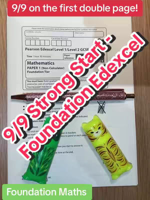 The cover image shows a close-up view of a GCSE mathematics exam paper. The top half of the paper is visible, with text overlayed proclaiming a 'Strong Start' and '9/9' score.  Two novelty shaped pen holding items, are present on either side of the paper.