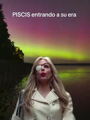 A woman with blonde hair and an eye patch looks up with a dramatic expression against a backdrop of a colorful sunset and a body of water. Text overlayed on the image says 'PISCIS entrando a su era'.
