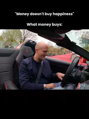 A man is driving a red convertible. The text overlayed is a quote in white font on a black background.