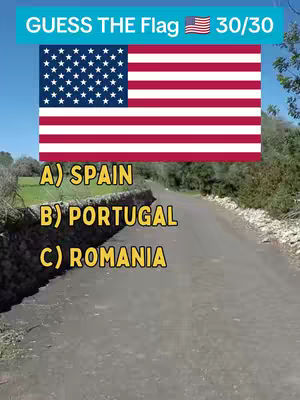 The cover image shows a multiple-choice quiz presented over a road. The top has a turquoise banner that says 'GUESS THE Flag', with the American flag beside the text. Underneath there's a stylized version of the American flag. Underneath the flag are the options A) SPAIN, B) PORTUGAL, and C) ROMANIA, written in yellow on top of a textured concrete wall with green foliage in the background, and blue sky overhead.