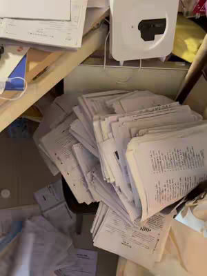 The cover image shows an overhead shot of a desk littered with papers, books, and various objects related to studying. A stack of papers is centrally positioned.